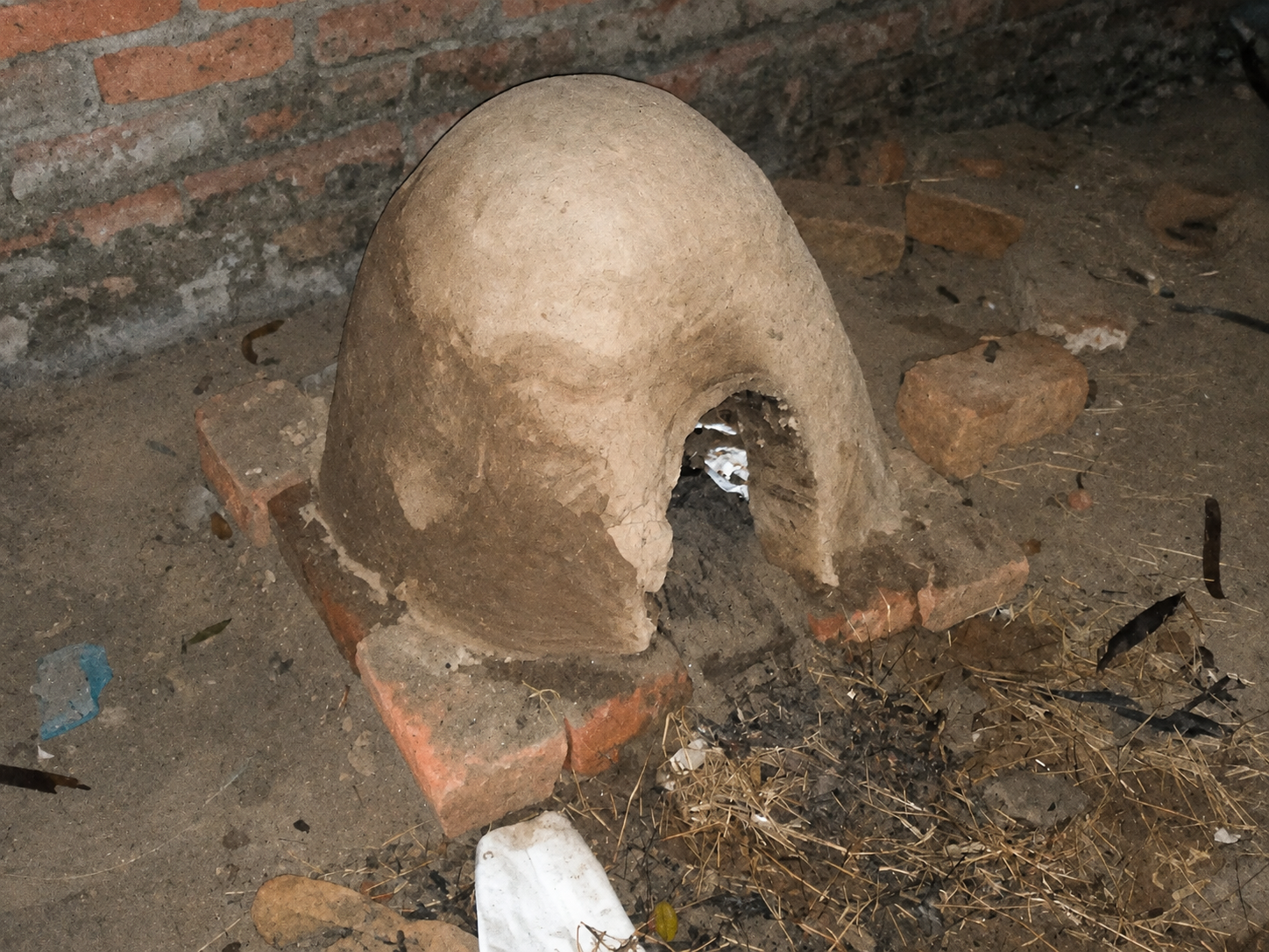 The oven doorway opened while the internal sand form is being removed