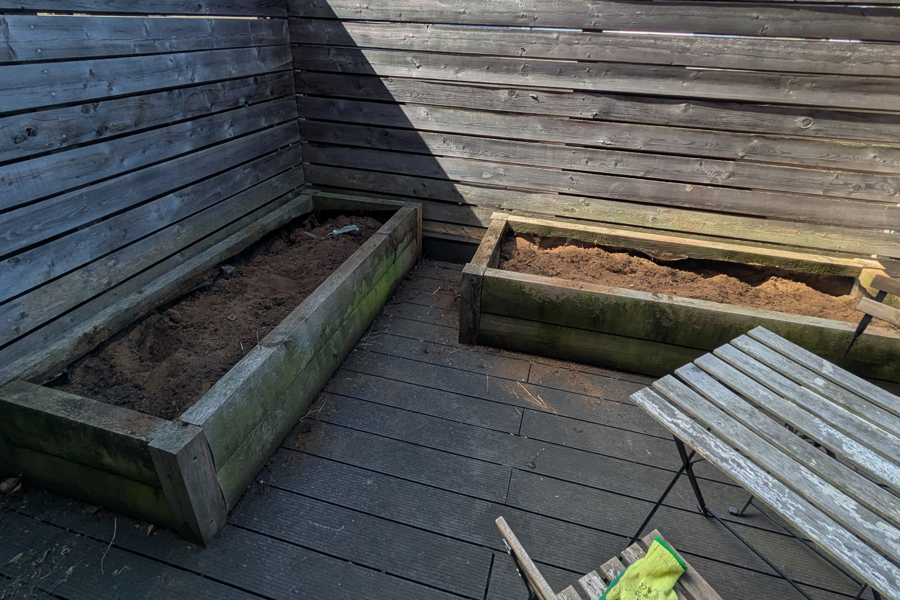The cleared garden planters refilled and levelled with fresh soil