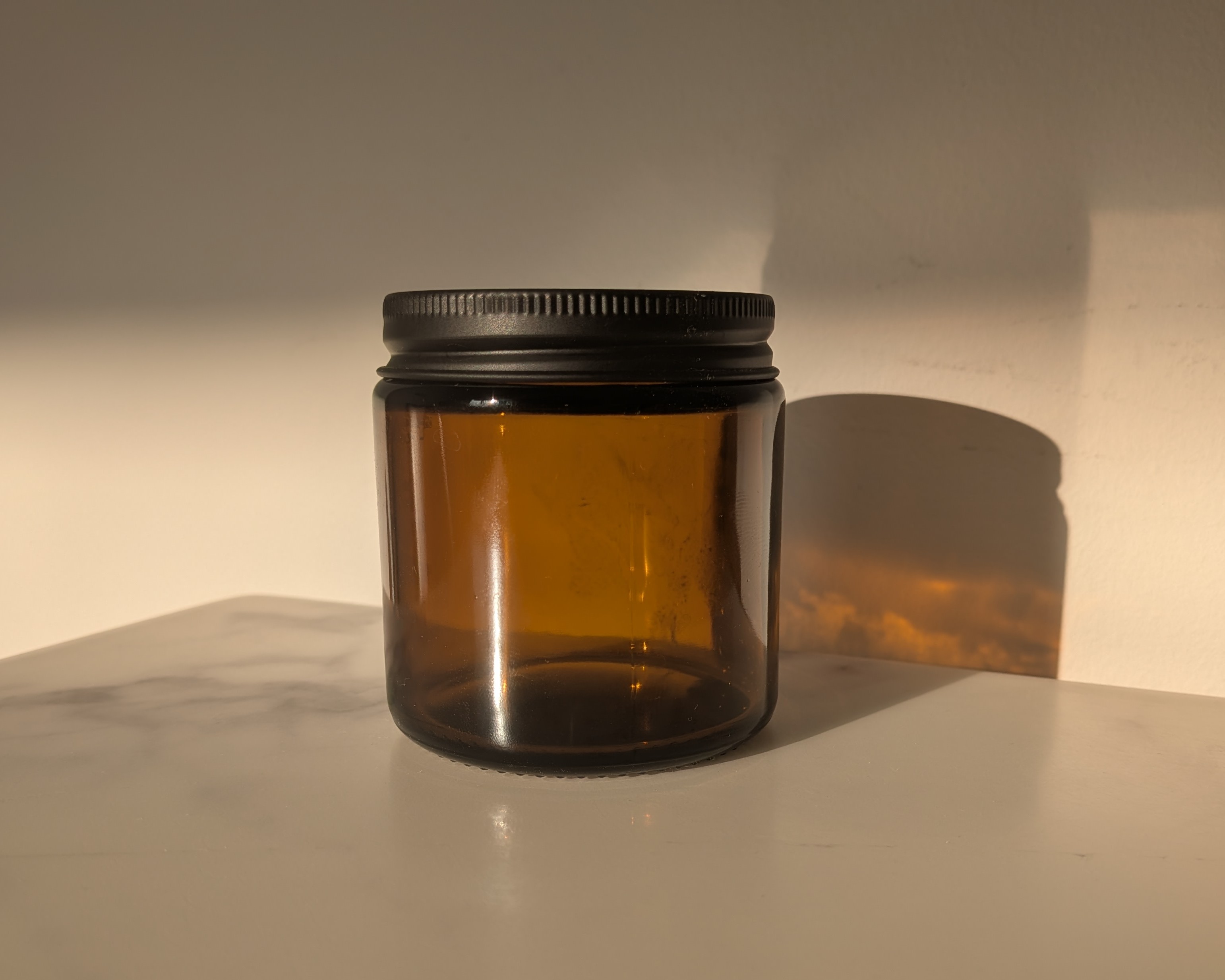 The empty amber candle jar before the electronics were fitted