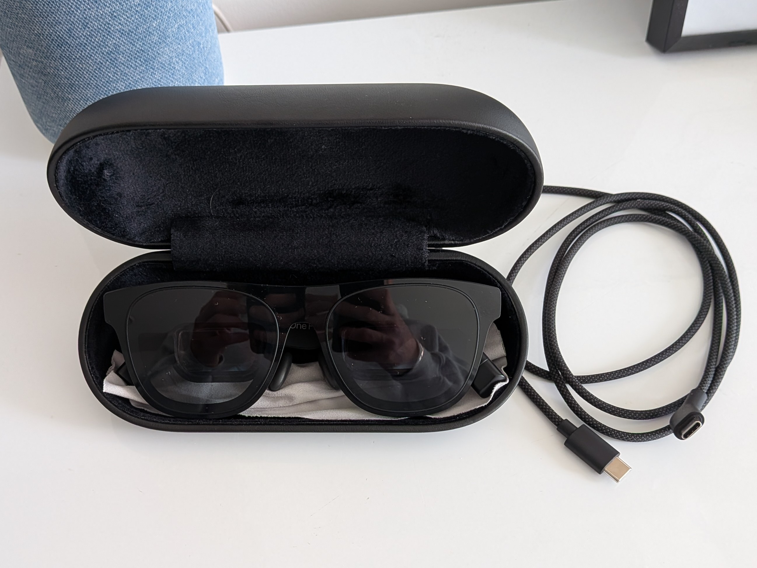The XREAL One Pro glasses in their protective case